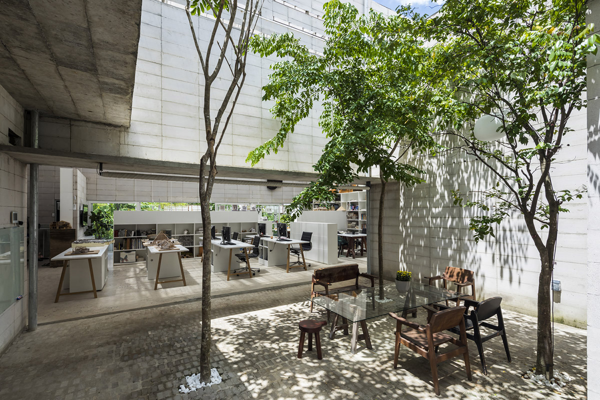 An office in Vietnam protects its own micro-climate with continuous spaces and internal courtyards