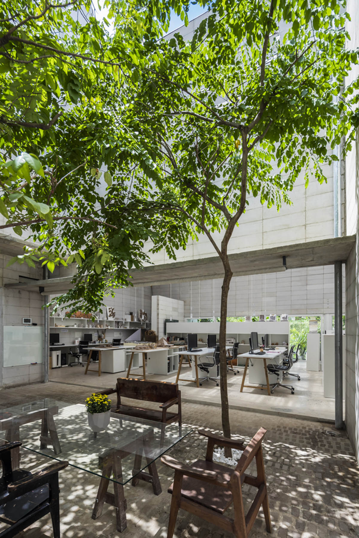 An office in Vietnam protects its own micro-climate with continuous spaces and internal courtyards