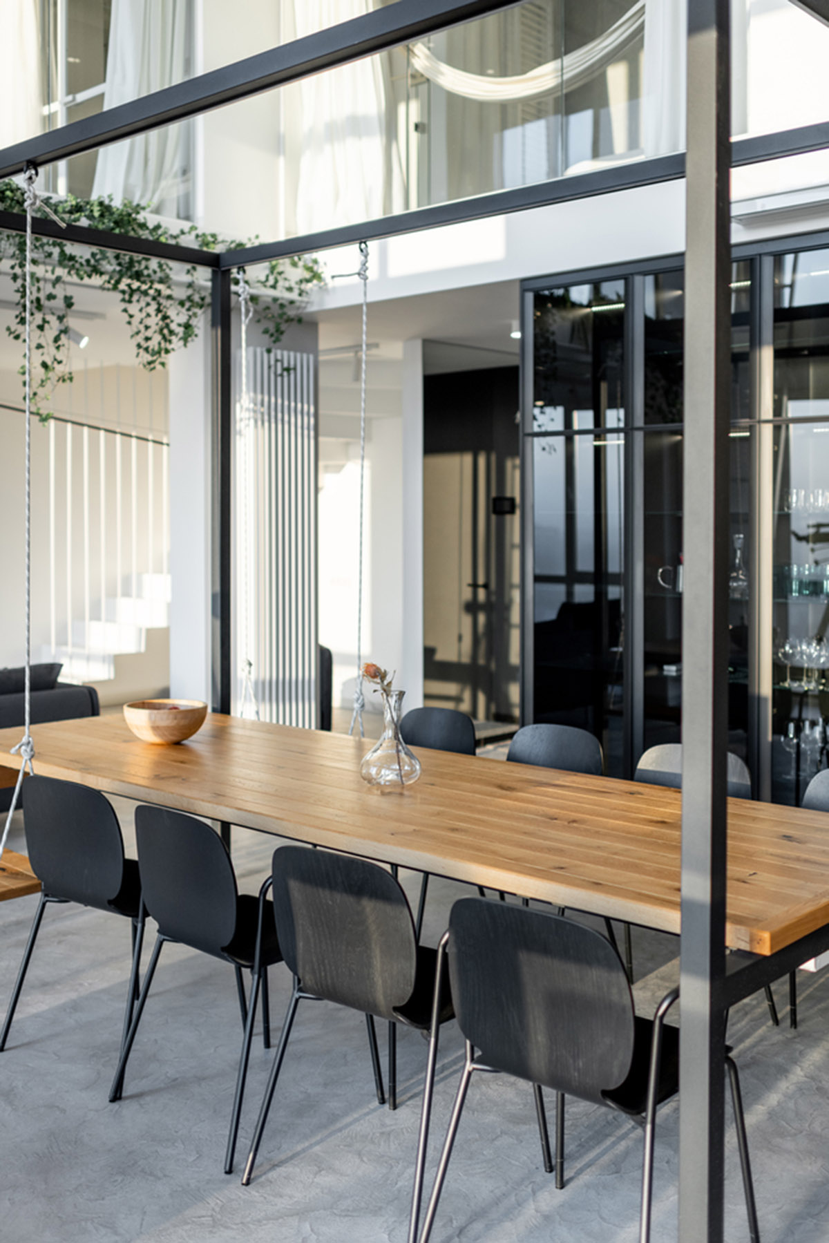 Metal framed-table, glass partitions, green infills make this interior space vivid and light in Lviv