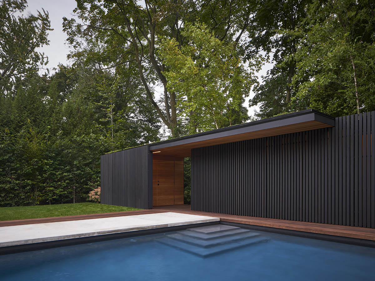 Vertical cedar battens wrap this pavilion by Amantea Architects in a lush green landscape in Toronto