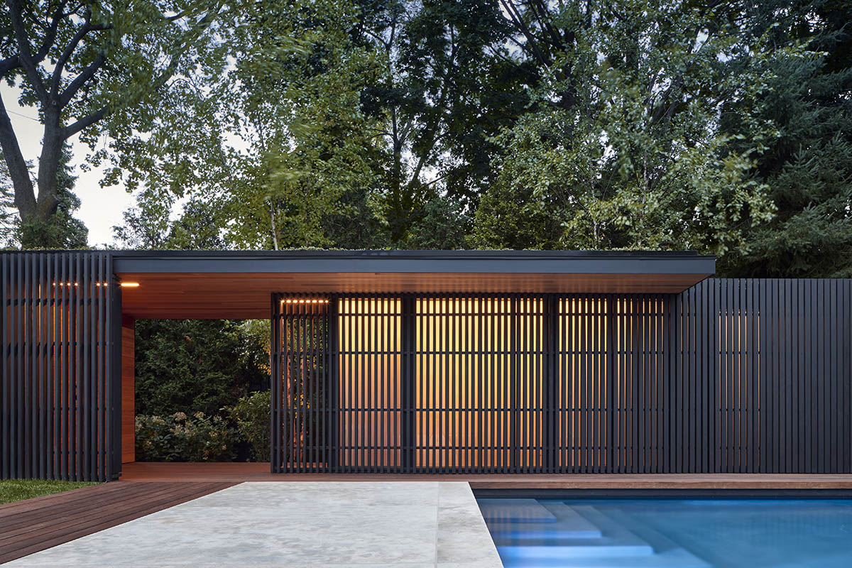 Vertical cedar battens wrap this pavilion by Amantea Architects in a lush green landscape in Toronto