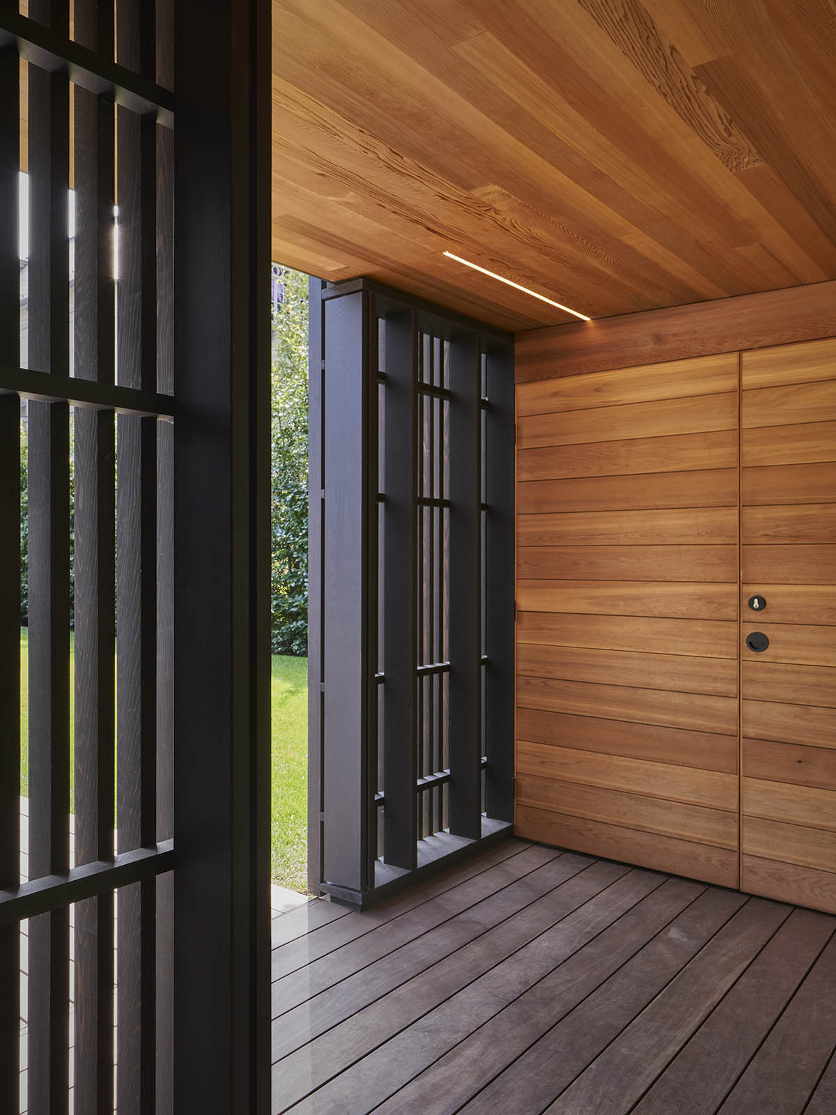 Vertical cedar battens wrap this pavilion by Amantea Architects in a lush green landscape in Toronto