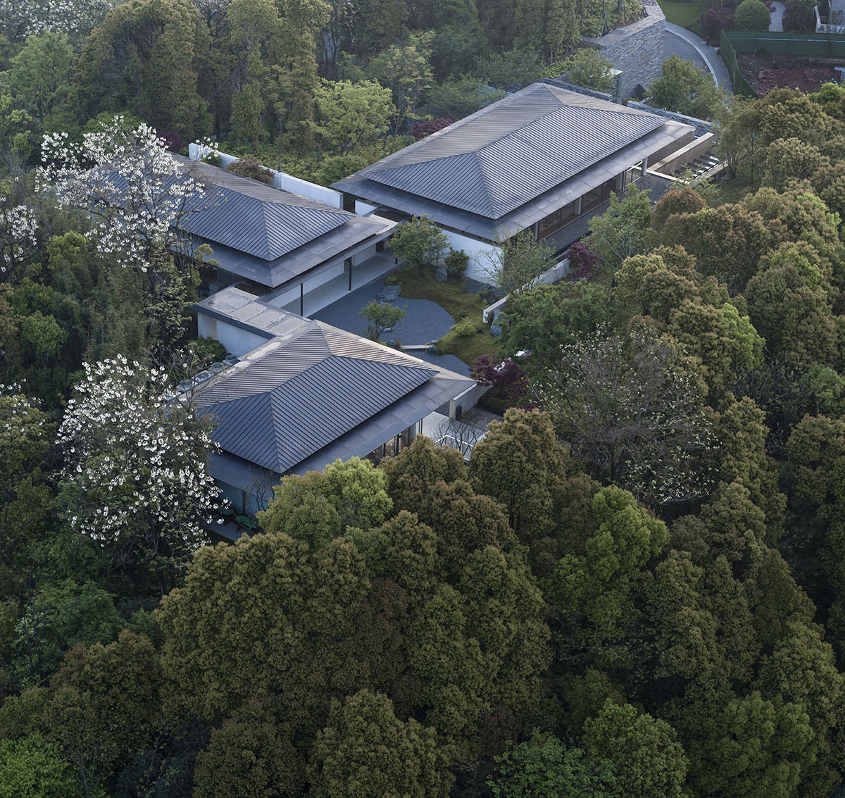 Hangzhou 9M Architectural Design embedded experience center with Large pieces of glasses in the hill