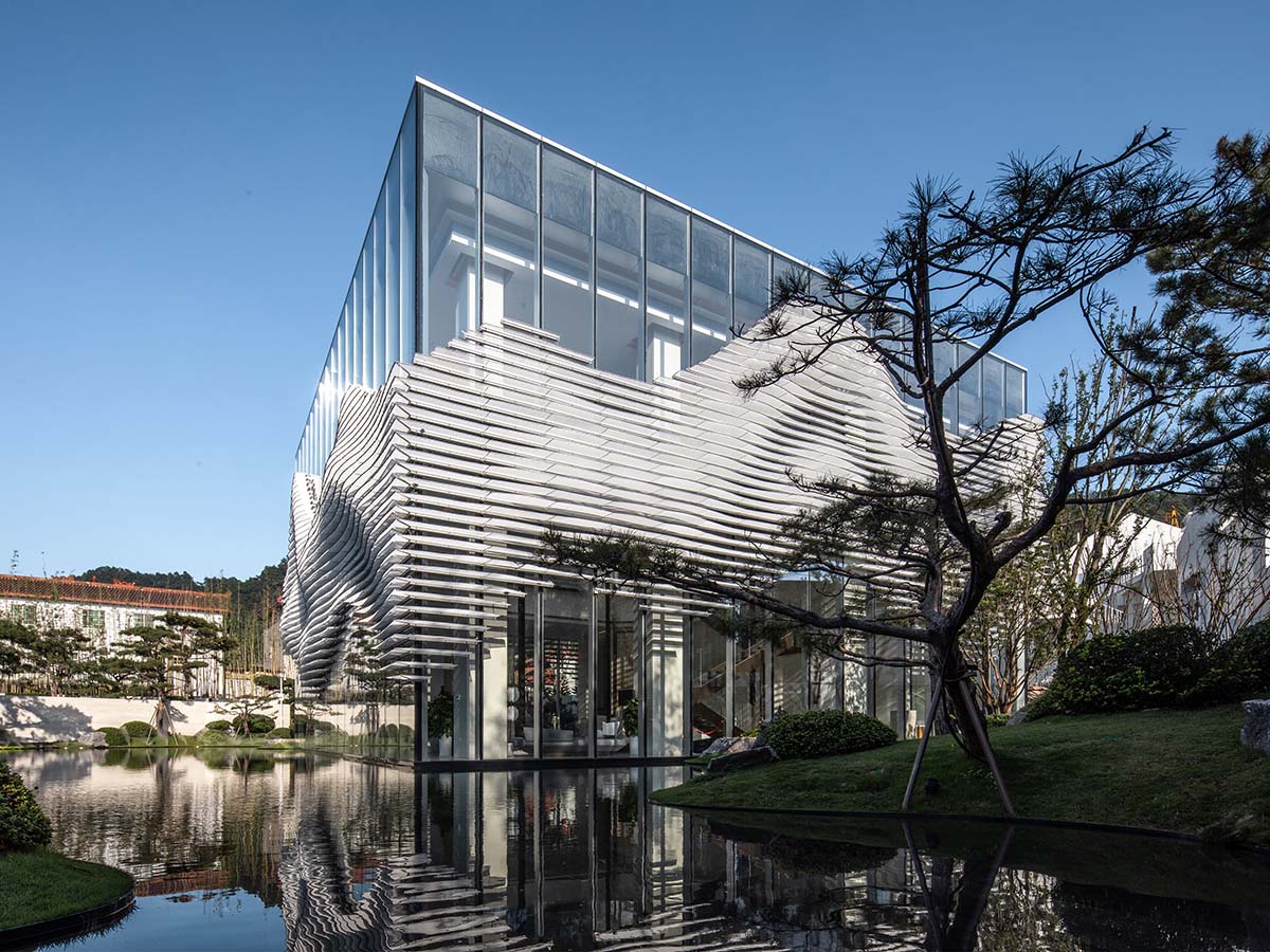 aoe wraps this sales pavilion with perforated plates that create a long scroll landscape painting