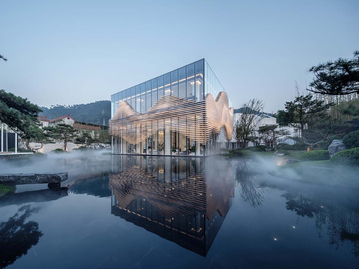 aoe wraps this sales pavilion with perforated plates that create a long scroll landscape painting