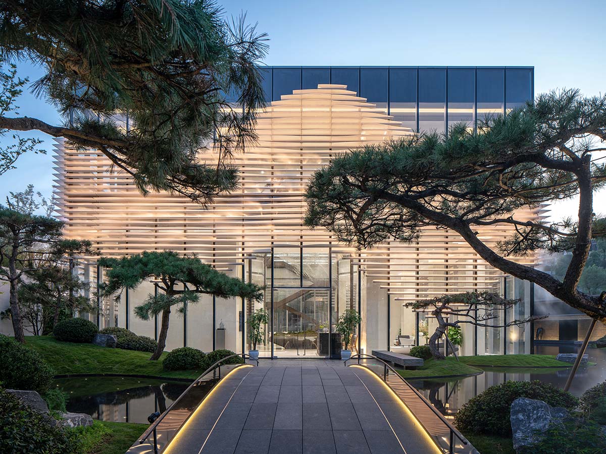 aoe wraps this sales pavilion with perforated plates that create a long scroll landscape painting