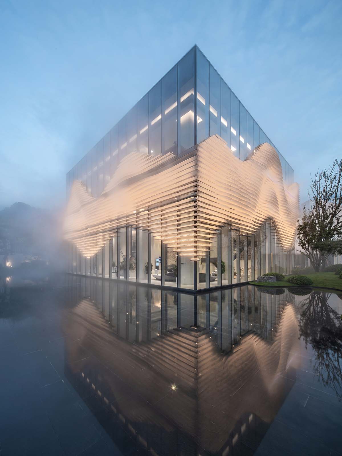 aoe wraps this sales pavilion with perforated plates that create a long scroll landscape painting