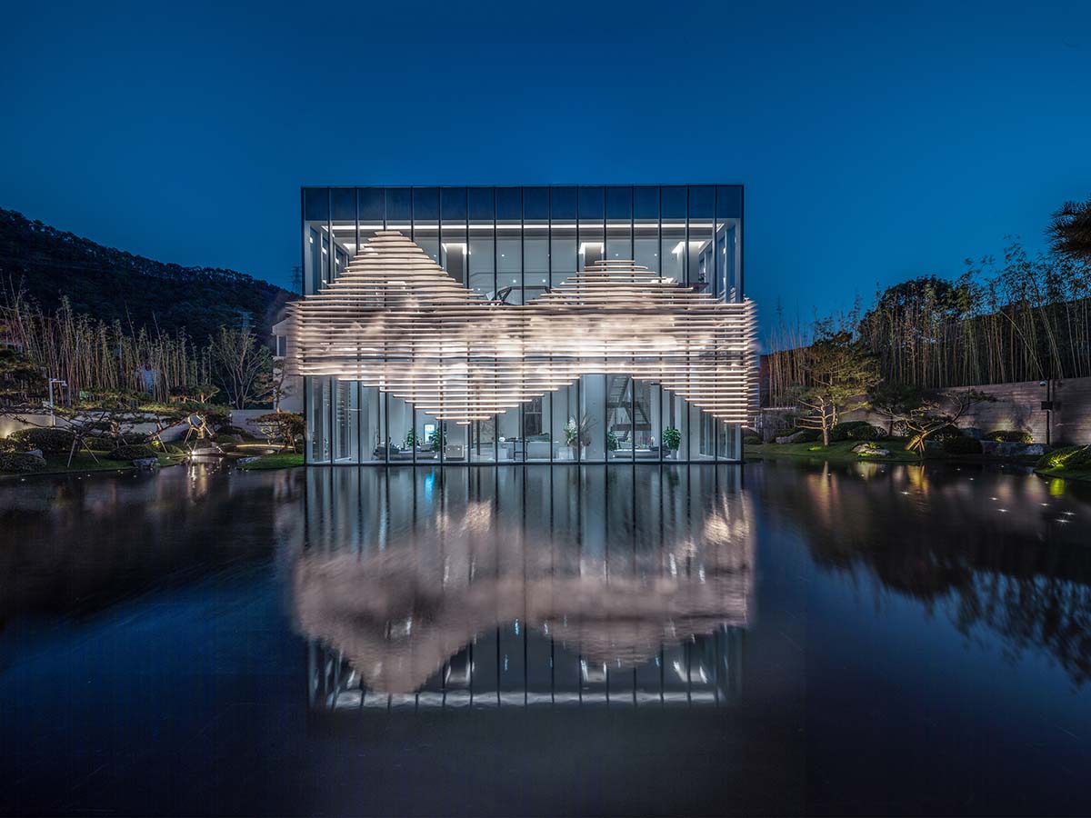 aoe wraps this sales pavilion with perforated plates that create a long scroll landscape painting