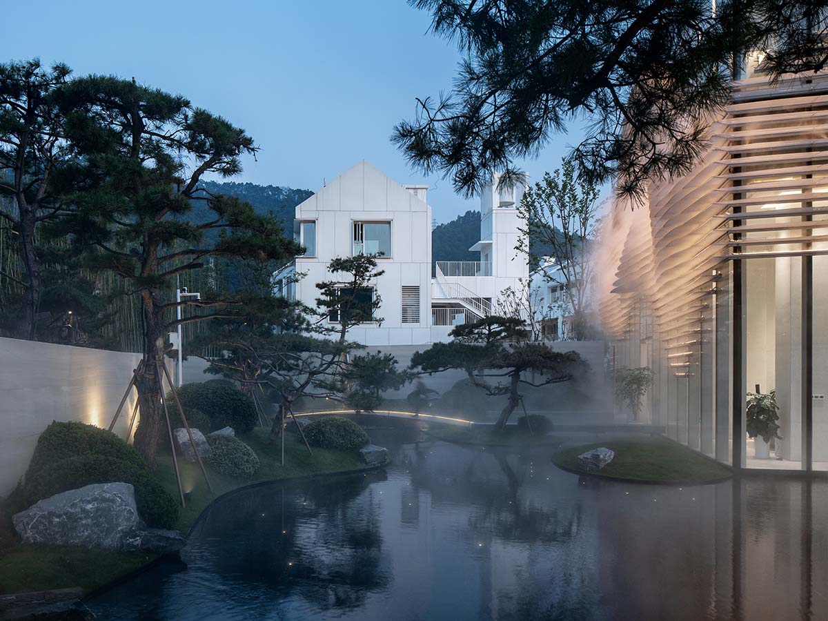 aoe wraps this sales pavilion with perforated plates that create a long scroll landscape painting