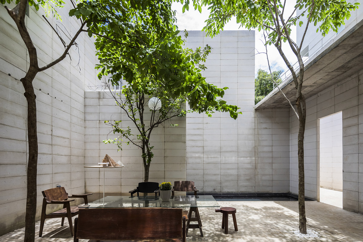 An office in Vietnam protects its own micro-climate with continuous spaces and internal courtyards