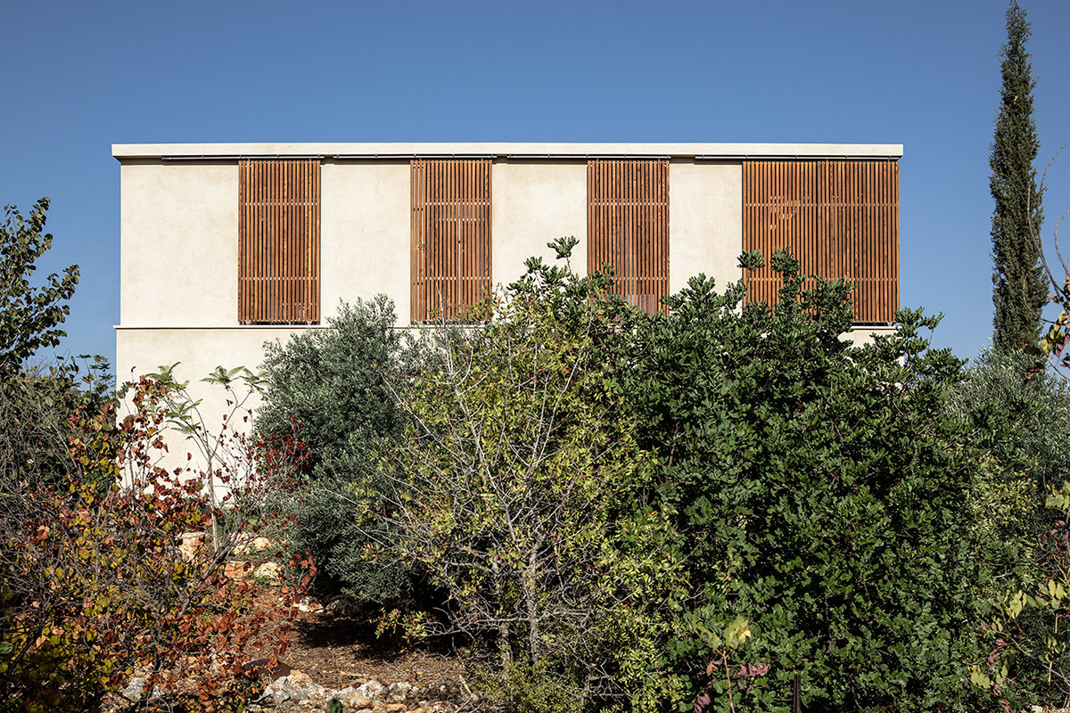 Golany Architects completes concrete private residence with wooden shutters in the Galilee