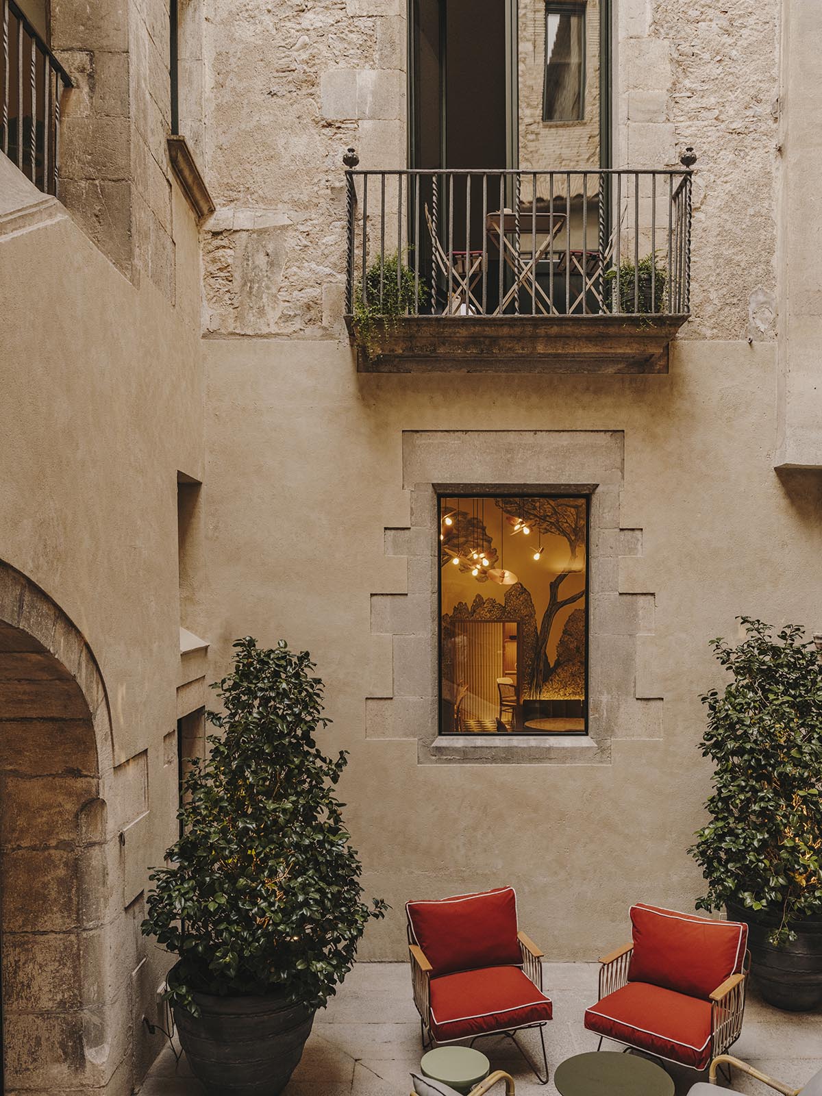 El Equipo Creativo converts 18th-century palace into hotel with rich textures and colors in Girona