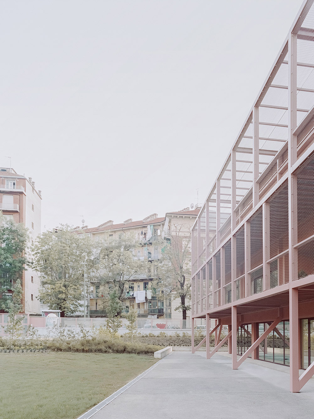 BDR bureau completes community school with pinkish steel framework in Turin