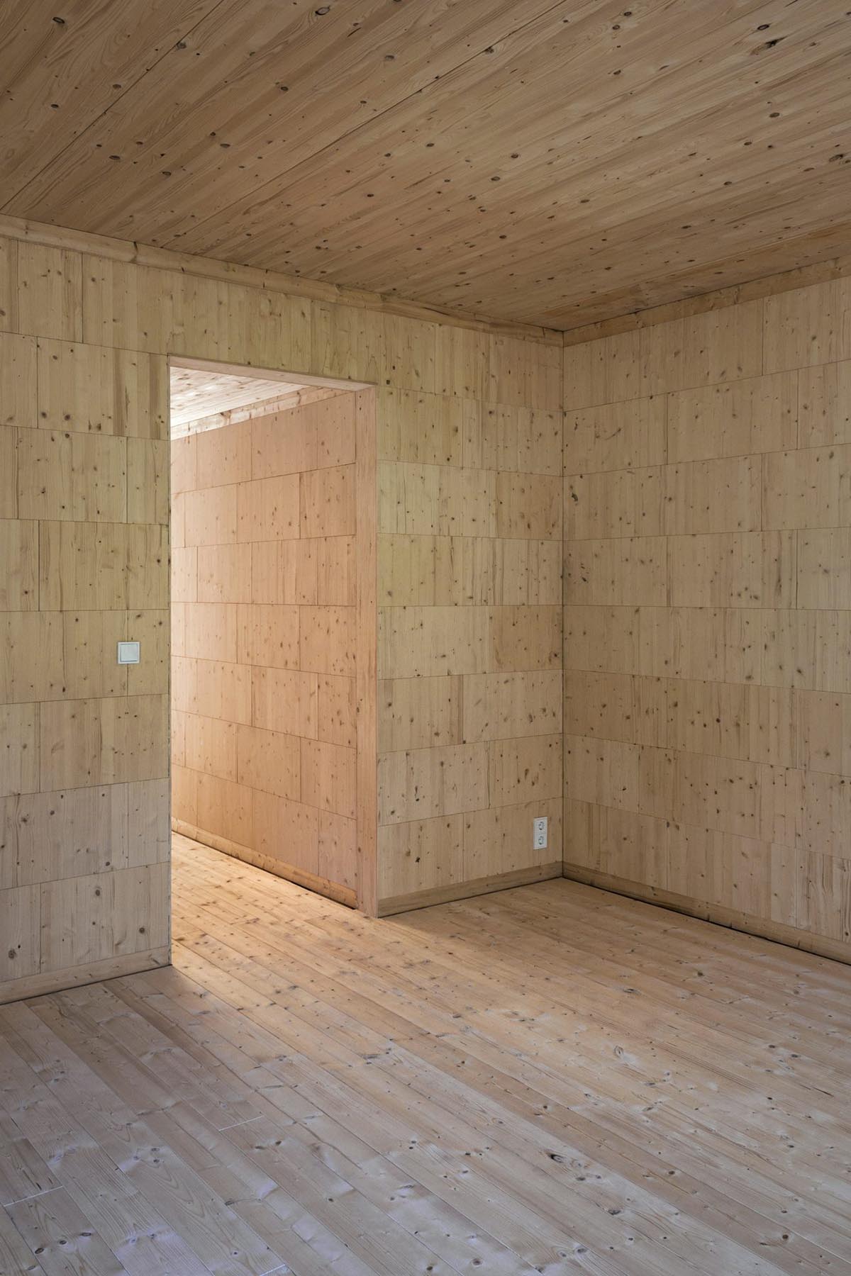 Zeller & Moye built private residence composed of interlocked timber cabins among pine trees