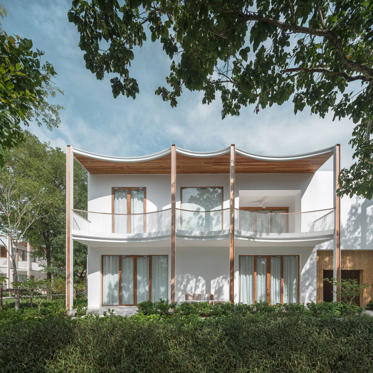 onion combines white concave and convex walls with colorful surfaces for beach resort in Thailand