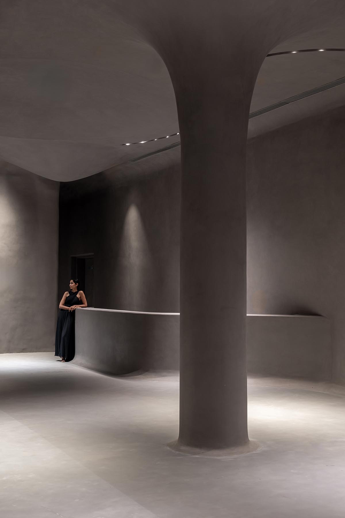 Grey fluid concrete wraps Aatma Manthan Museum by Sanjay Puri Architects