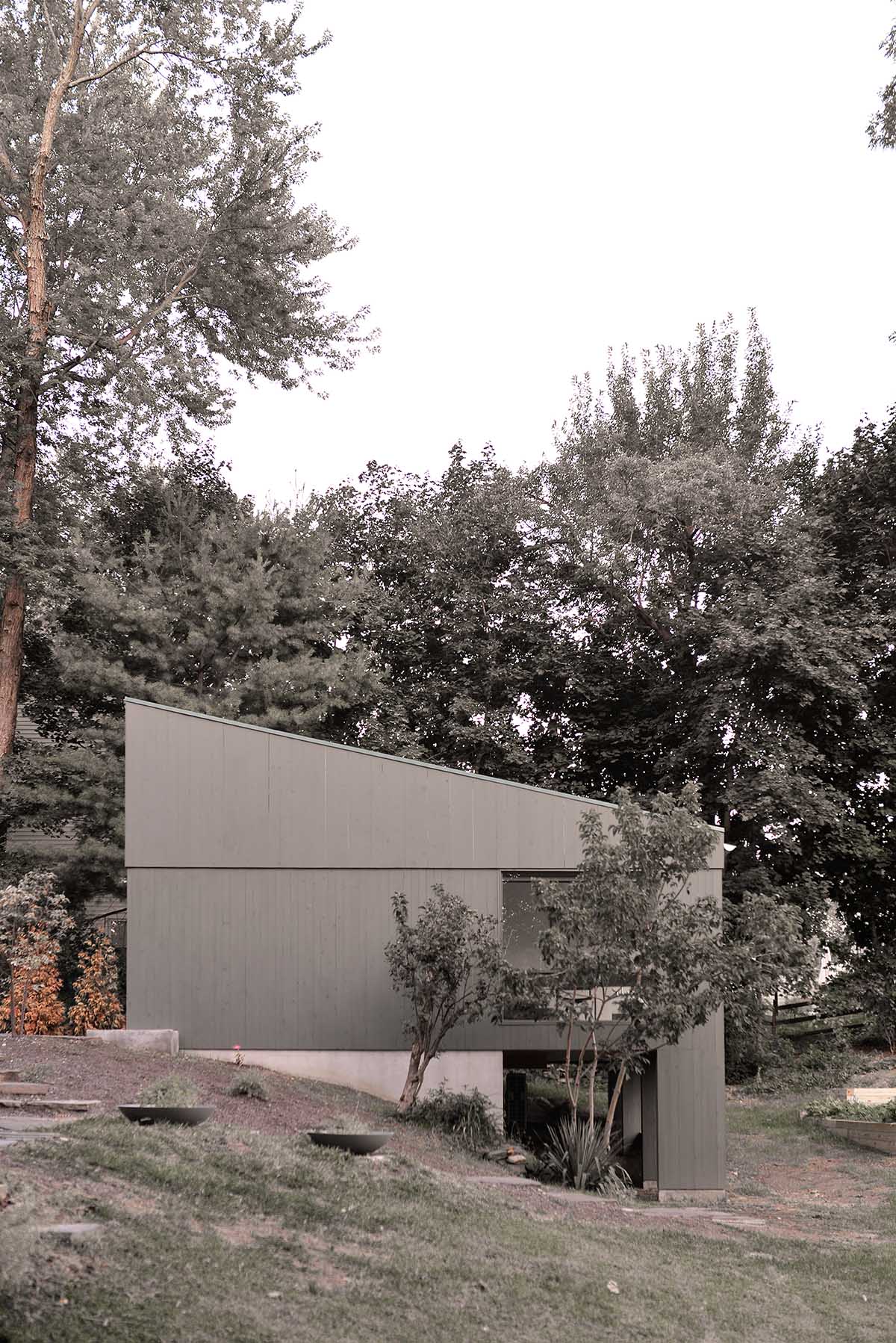 An artist's studio floats and illuminates in the landscape in Germantown