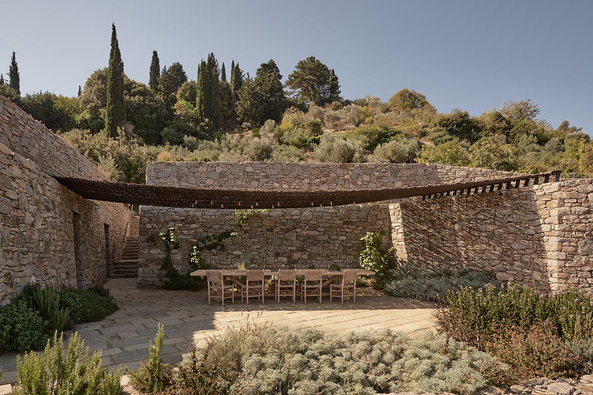 Terraced stonewalls sprawl down to offer an exploratory route in an old vineyard in Samos