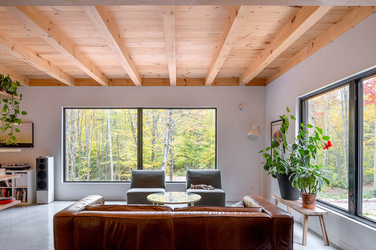 Country home is a wooden shelter that brings tranquility in the heart of the forest in Canada
