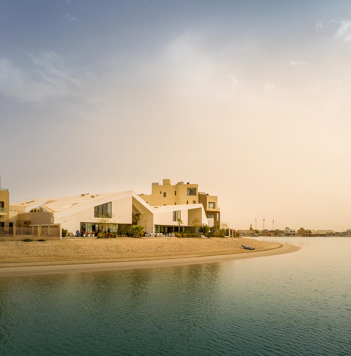 Family house is covered by folded roof to create a tent-like structure on Kuwait's seaside 