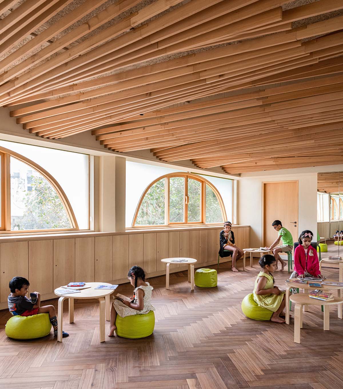 studio Hinge embeds a library under the wooden tree-like canopies in Mumbai