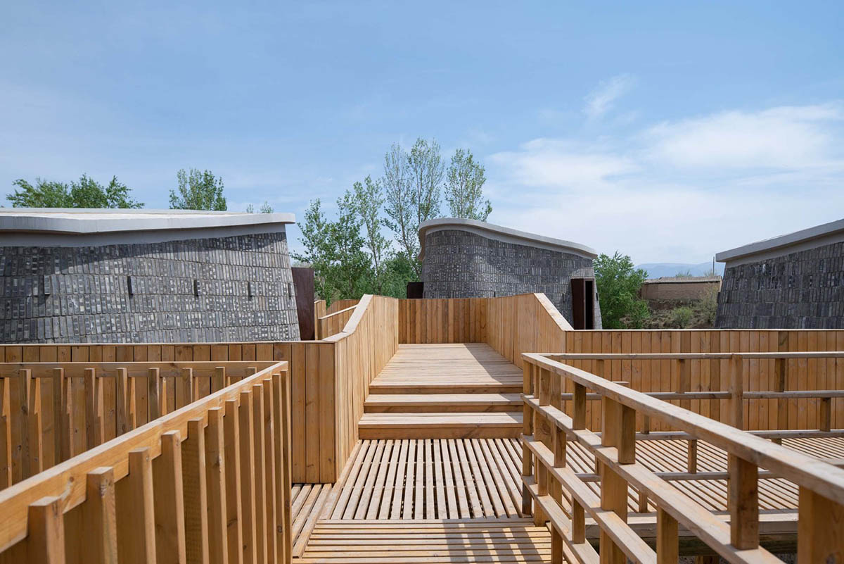 Hyperbolic vertical grottos are activated by a network of floating wooden bridges in China