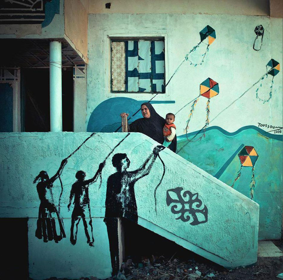 Mona Hassan captures Egyptian Village Festival Houses composed of colourful paintings by 40 artists