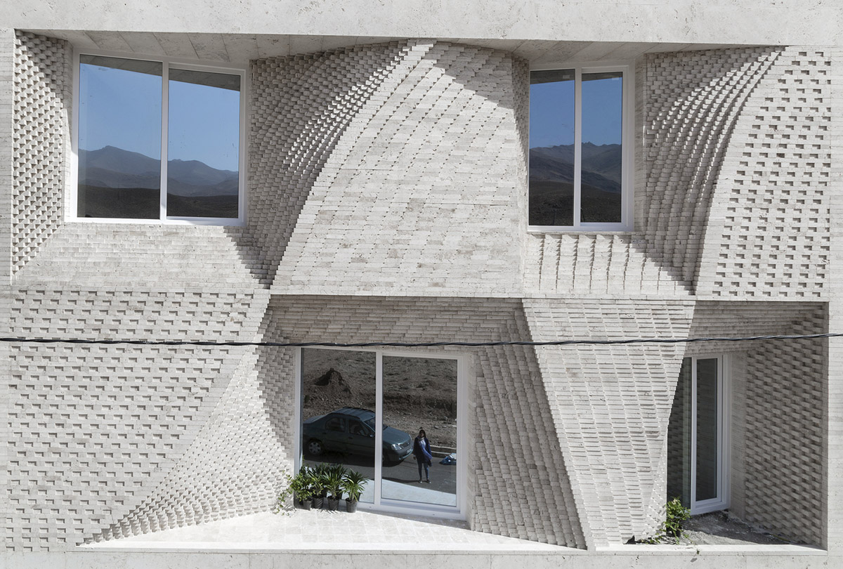 CAAT Studio creates spatial variations of stone on the facade of this Iranian residential building