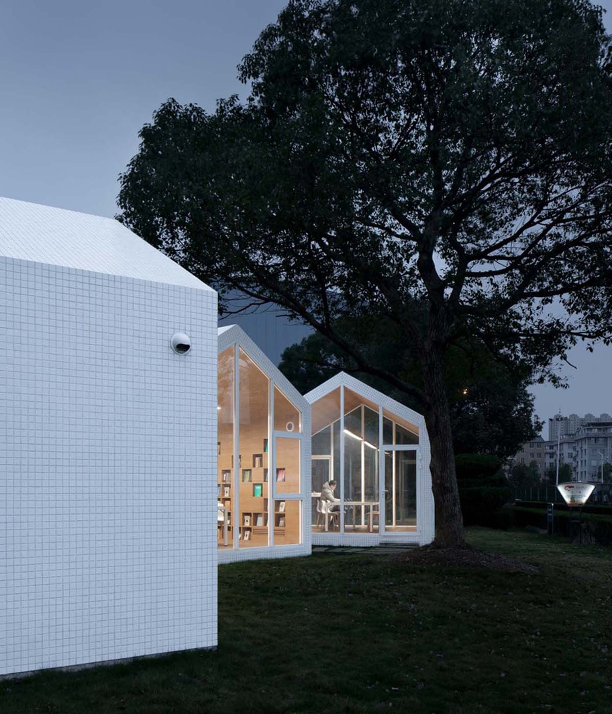 Four mini cabins by Yuan Architects scattered in a forest to create a reading village in Taizhou City
