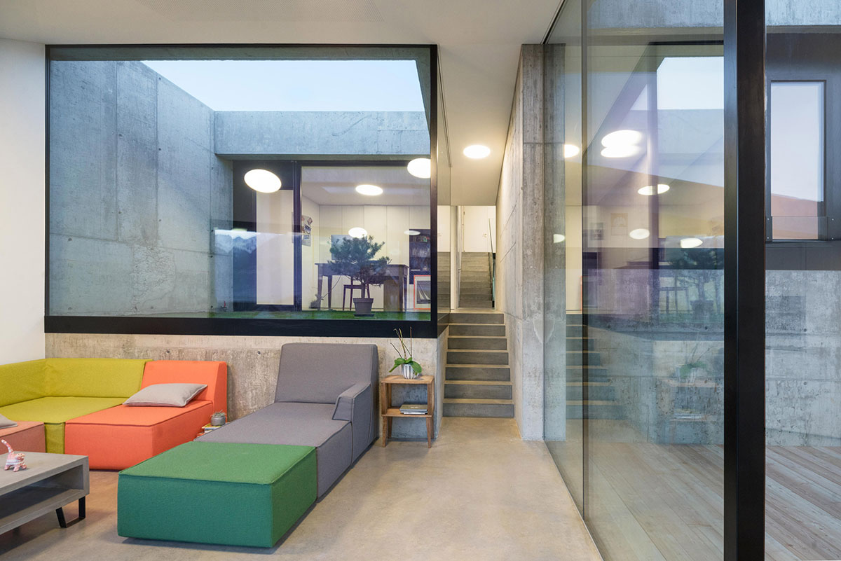 Anako Architecture completes slopped concrete residence in Switzerland