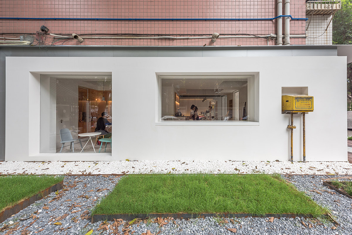 Lukstudio plays with cut-out volumes to transform old Chinese building into cafe and office