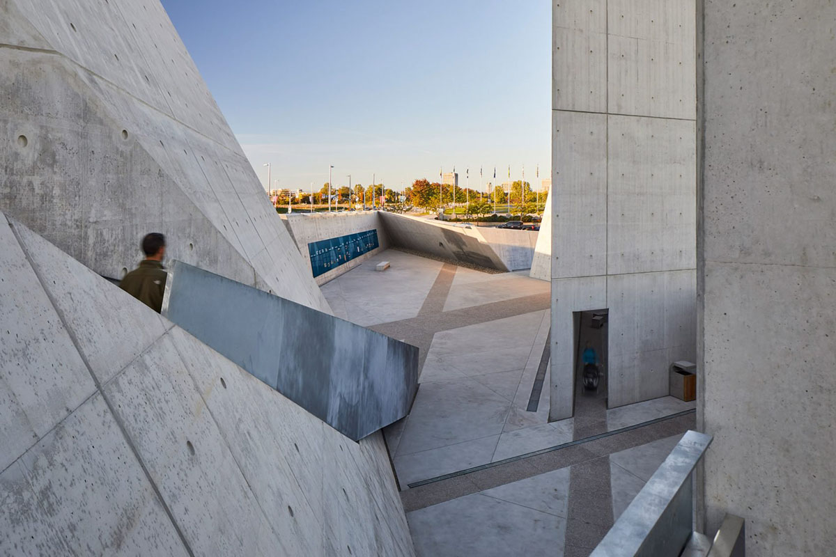 Daniel Libeskind’s Holocaust Monument features fragmented concrete walls creating rough landscape