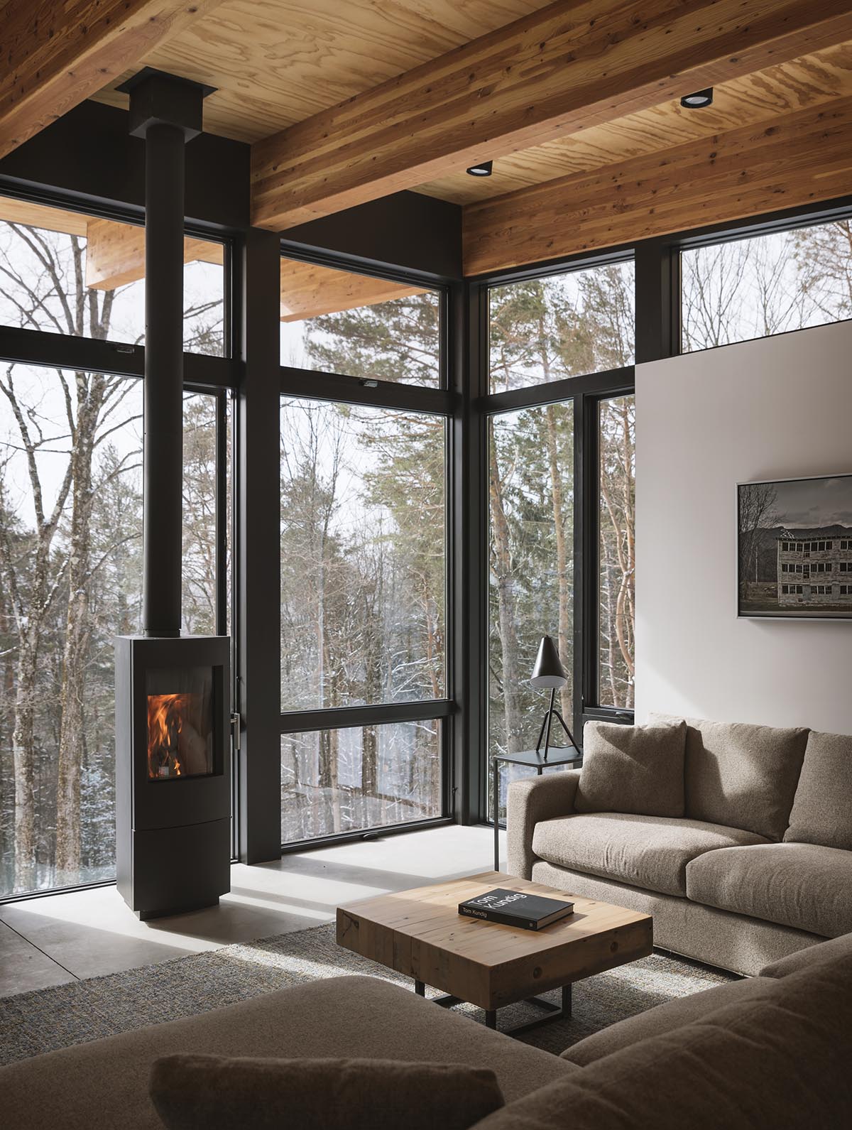 Olson Kundig creates compact and minimal family cabin in a heavily wooded landscape in Vermont