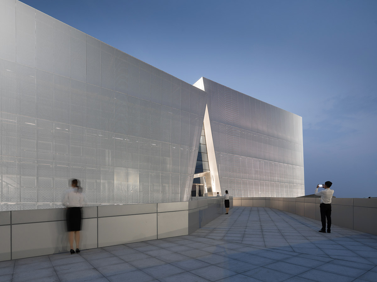 aoe built ShuiFa Info Town Property Exhibition Centre with all-white perforated volumes in China