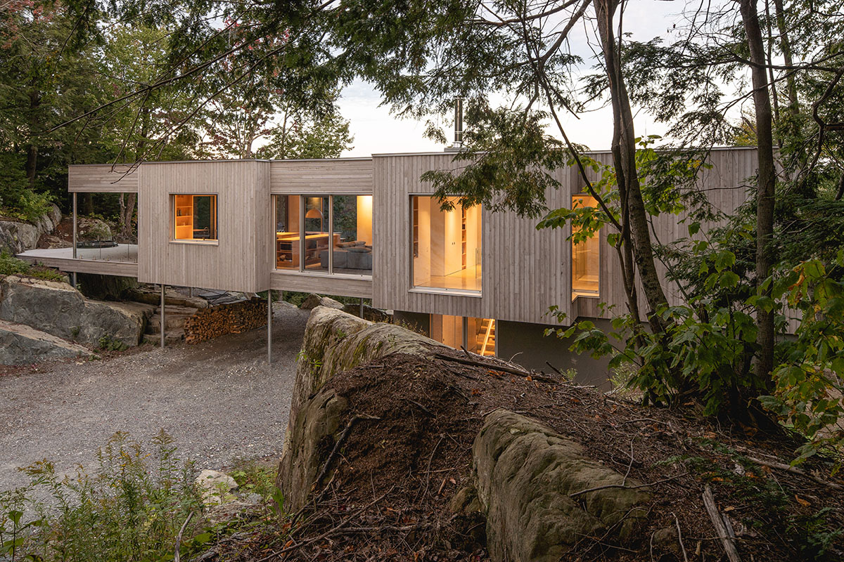 Natalie Dionne Architecture built wooden house raised on colums on a rocky landscape in Canada
