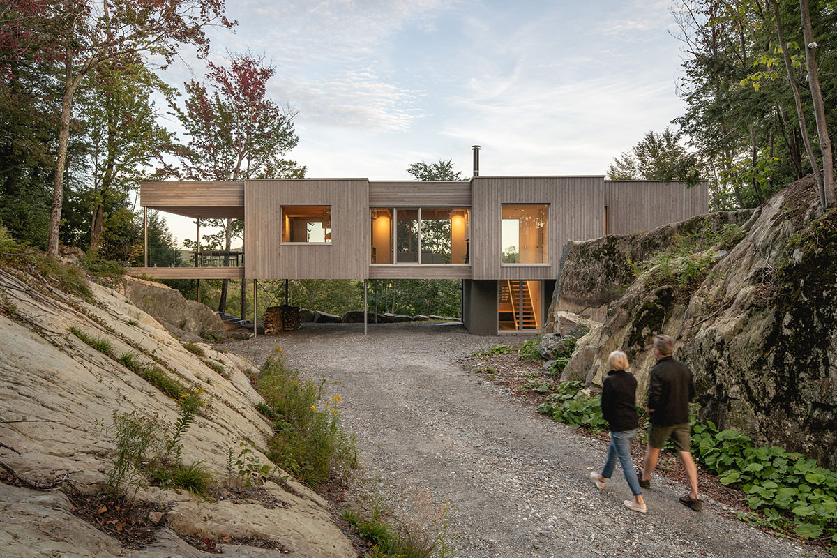 Natalie Dionne Architecture built wooden house raised on colums on a rocky landscape in Canada
