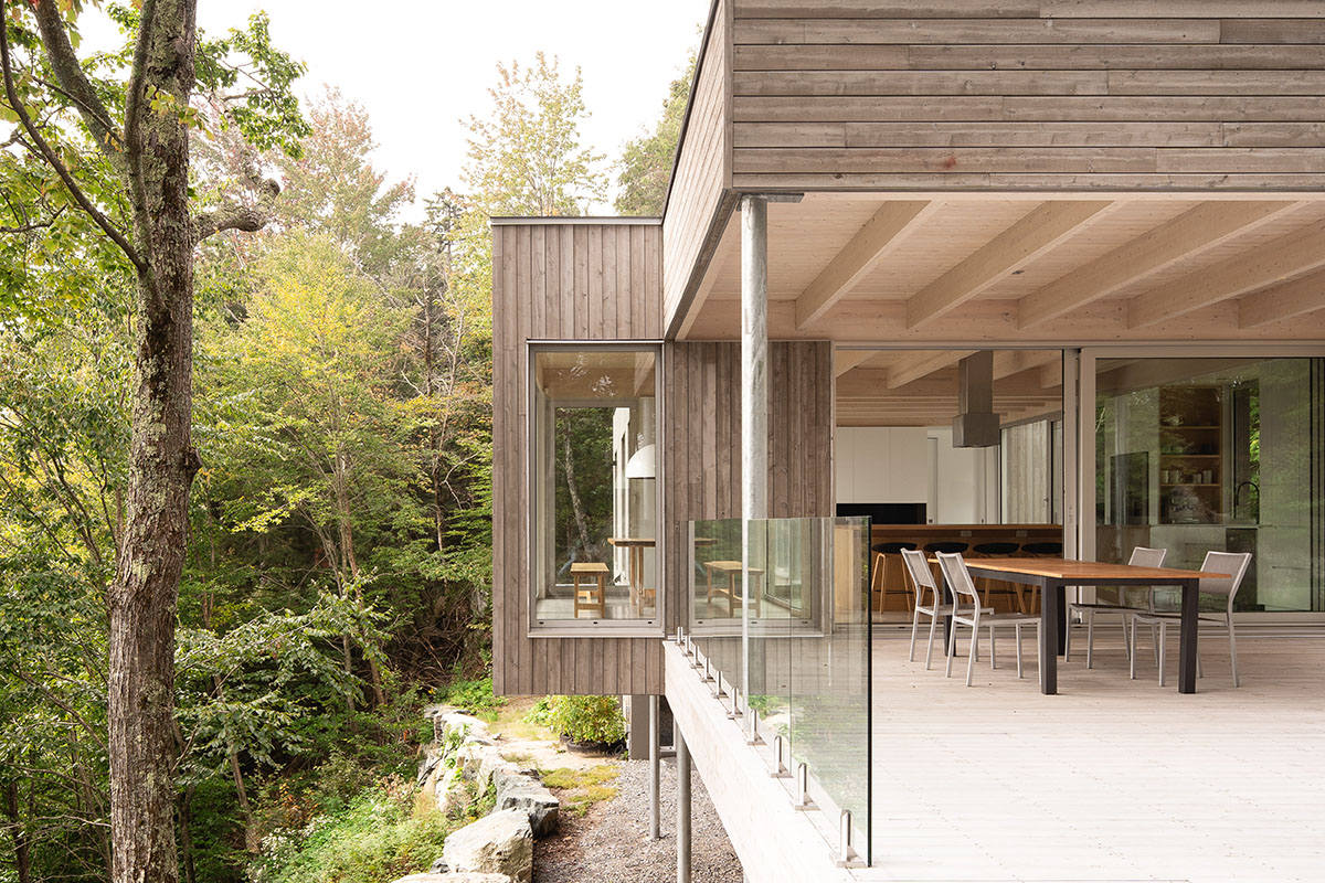 Natalie Dionne Architecture built wooden house raised on colums on a rocky landscape in Canada