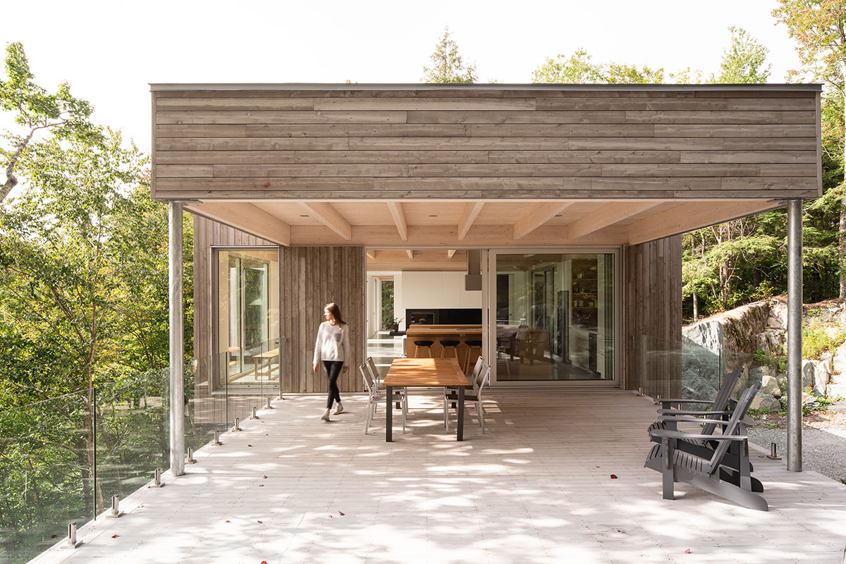 Natalie Dionne Architecture built wooden house raised on colums on a rocky landscape in Canada