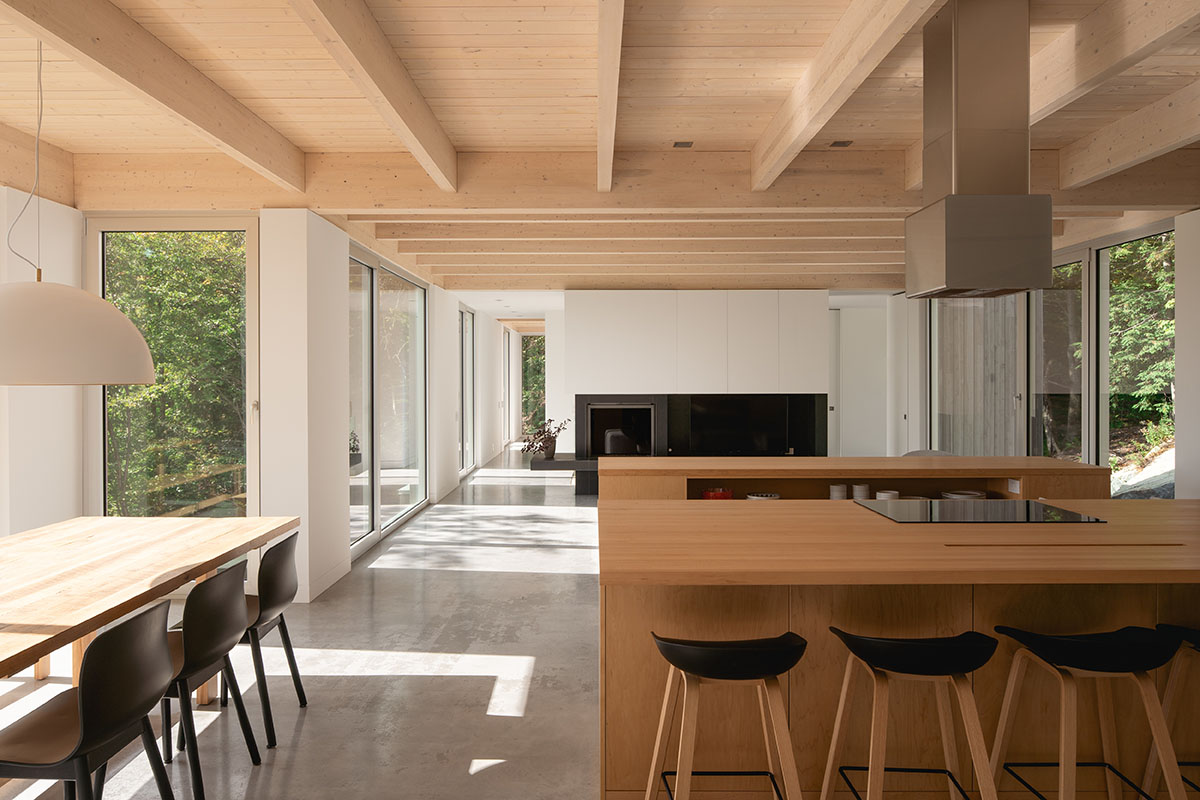 Natalie Dionne Architecture built wooden house raised on colums on a rocky landscape in Canada