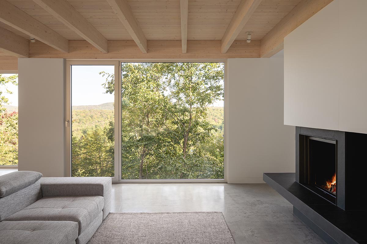 Natalie Dionne Architecture built wooden house raised on colums on a rocky landscape in Canada