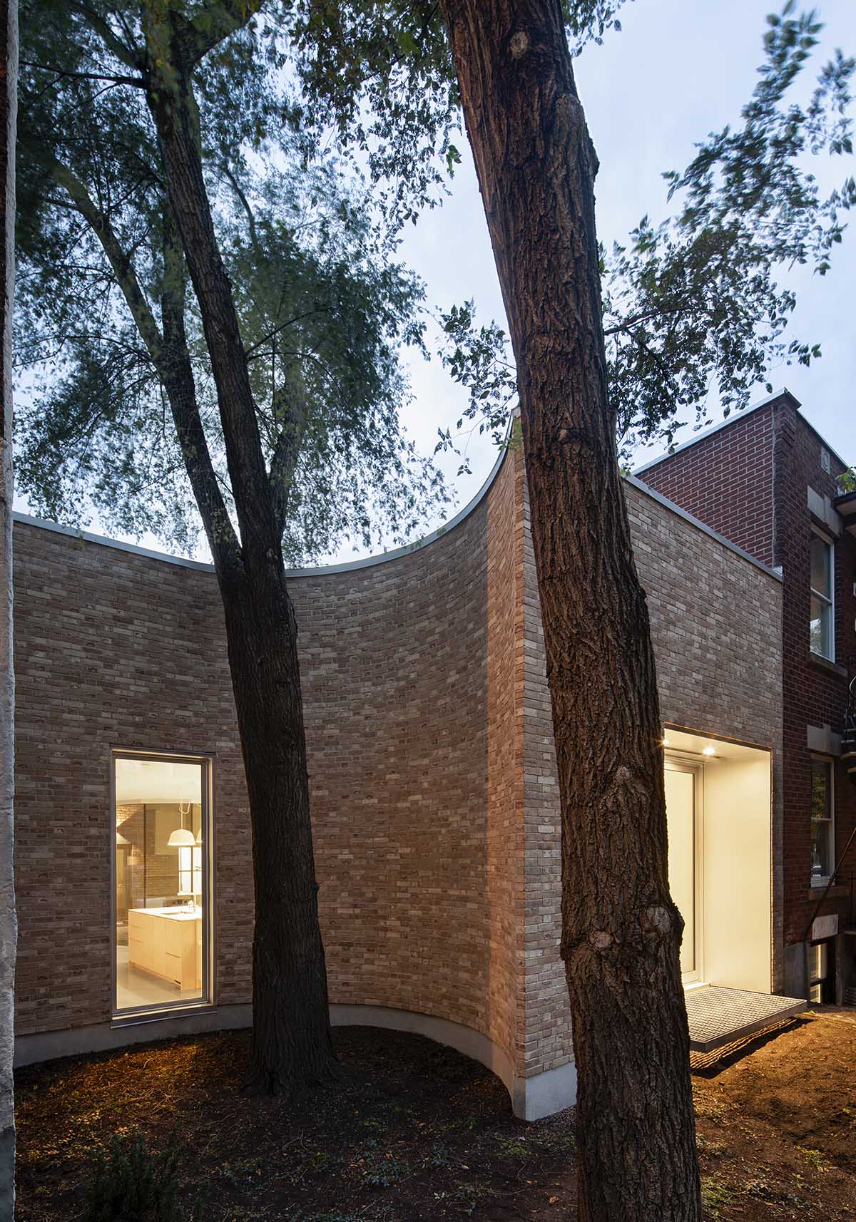 TBA adds curved and textured pale brick volume to Montreal’s heterogenous family neighborhood