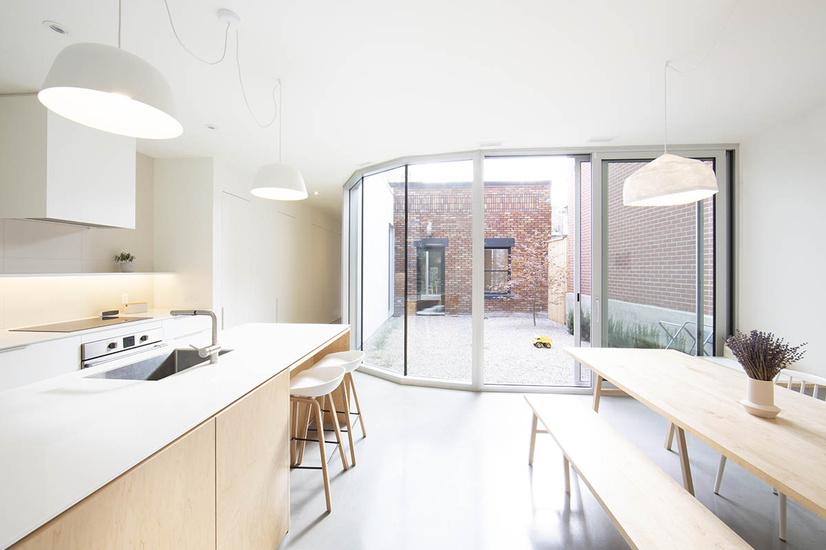 TBA adds curved and textured pale brick volume to Montreal’s heterogenous family neighborhood