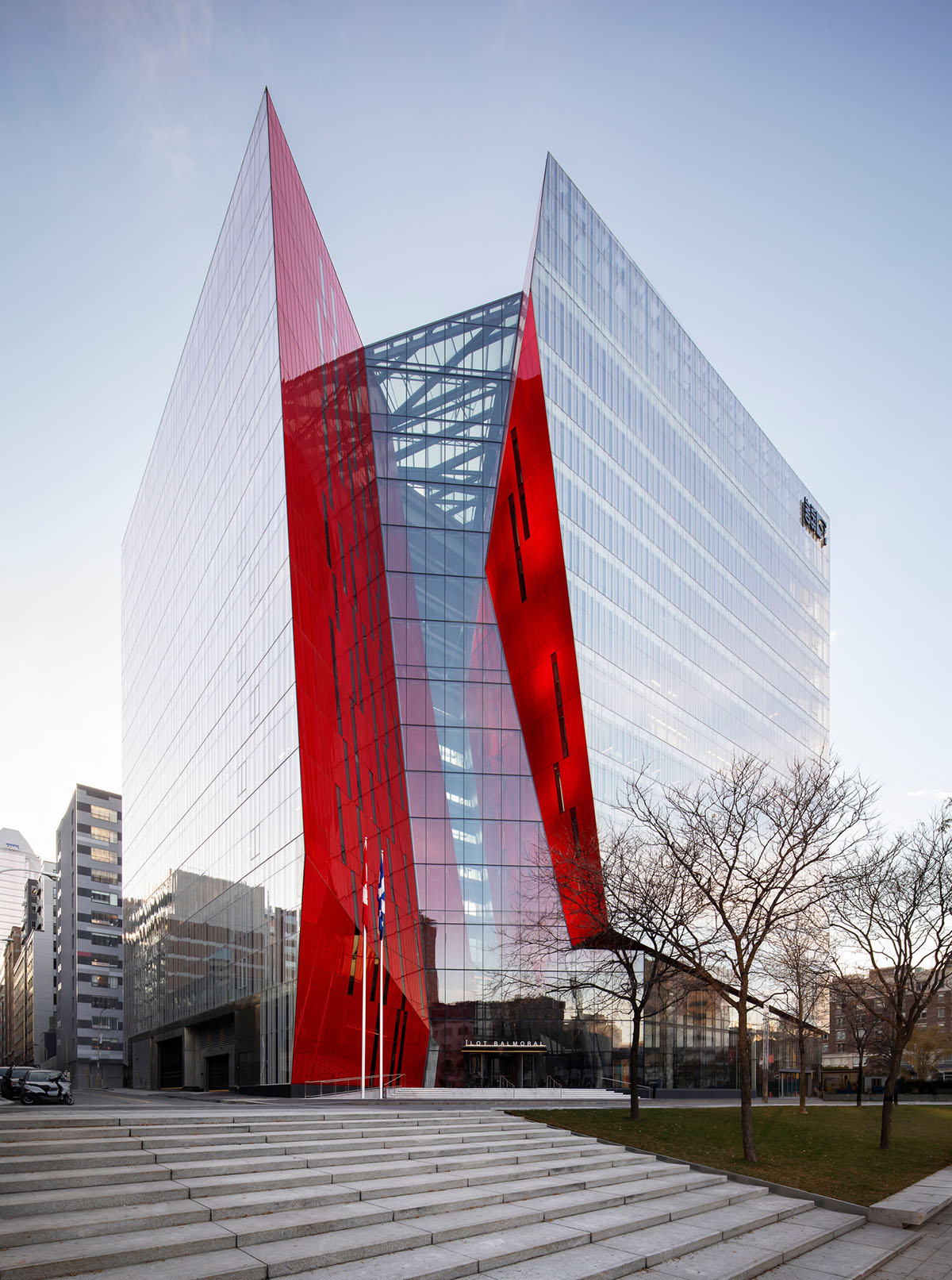 Provencher_Roy carves mixed-use office tower in Montréal with a red-colored diagonal slit