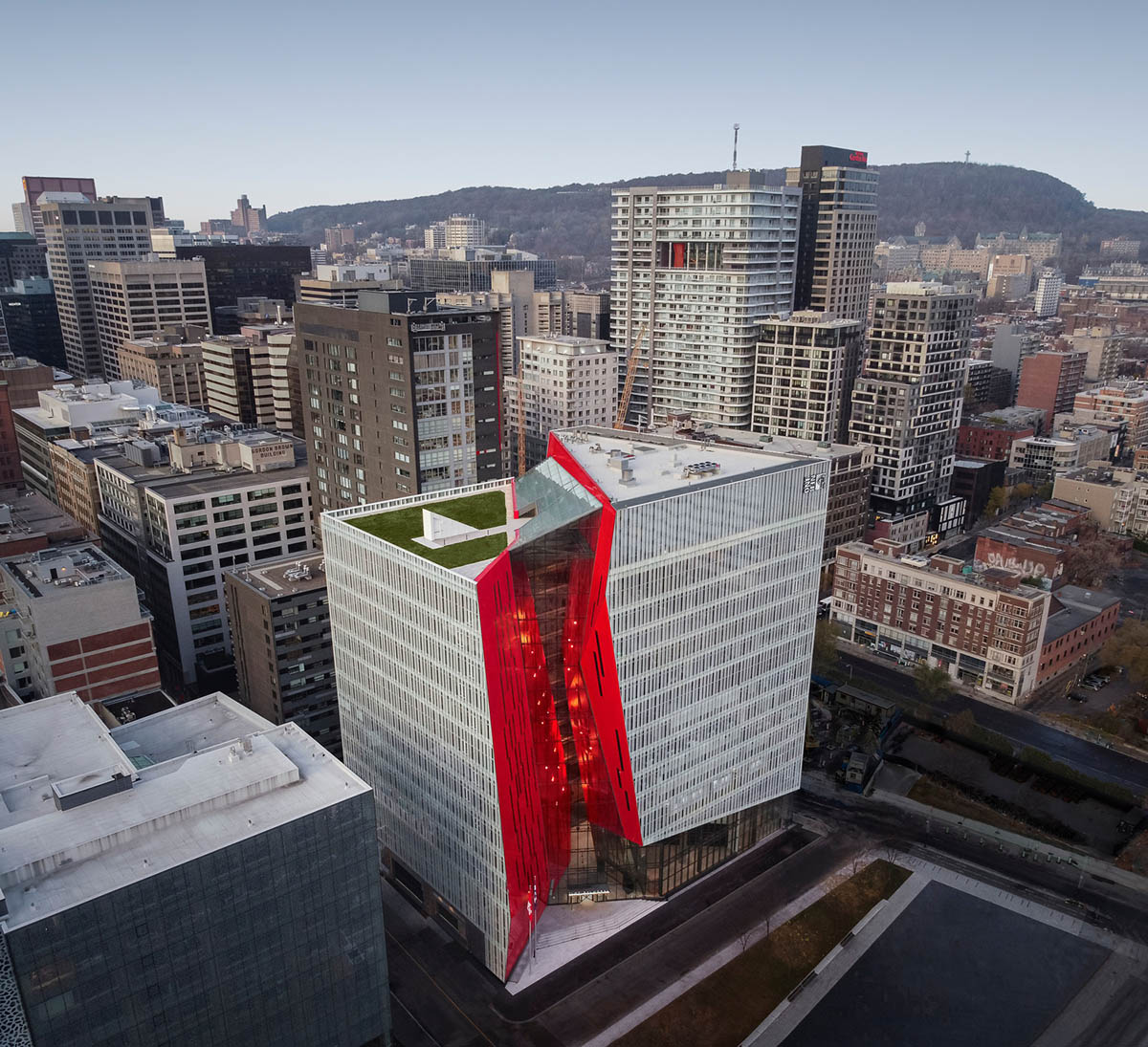 Provencher_Roy carves mixed-use office tower in Montréal with a red-colored diagonal slit
