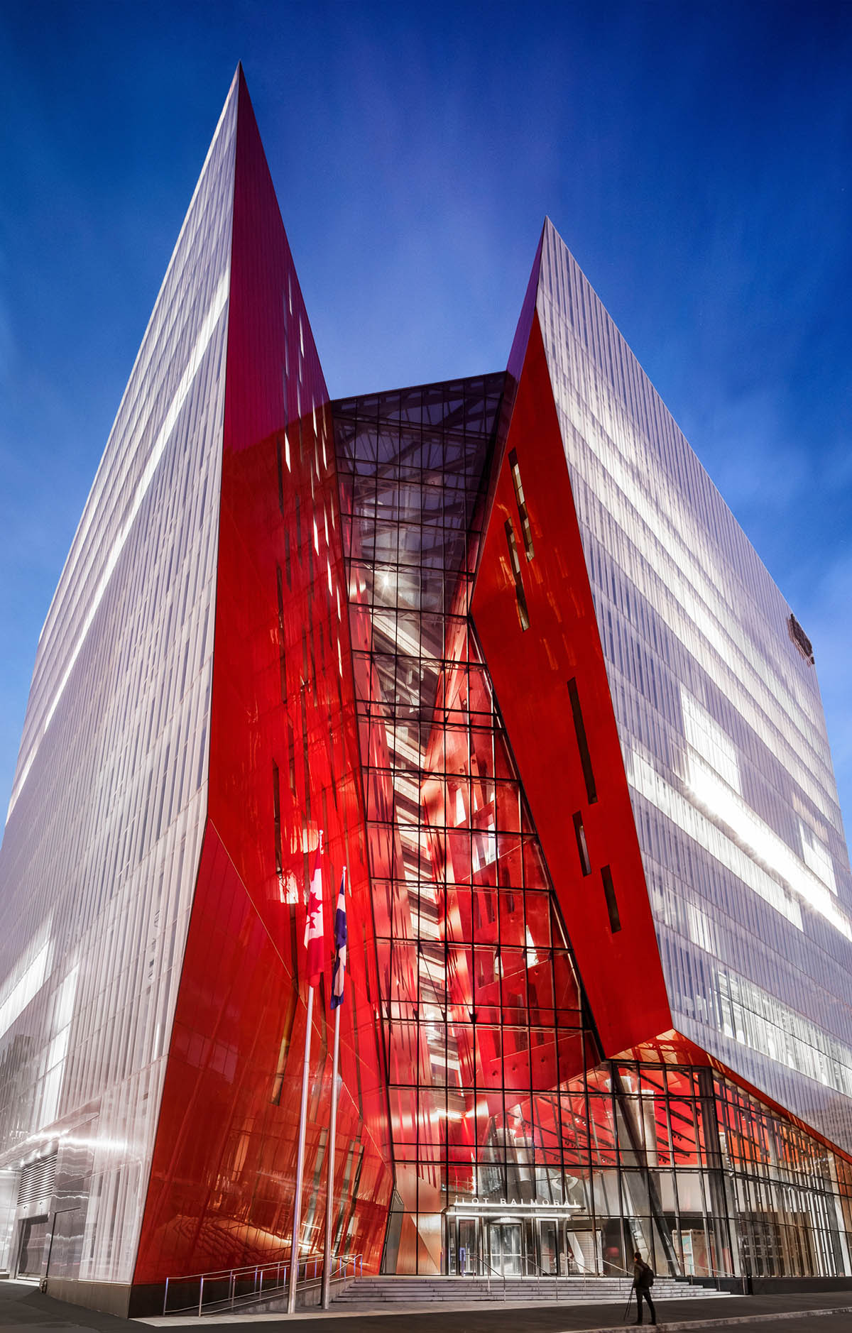 Provencher_Roy carves mixed-use office tower in Montréal with a red-colored diagonal slit