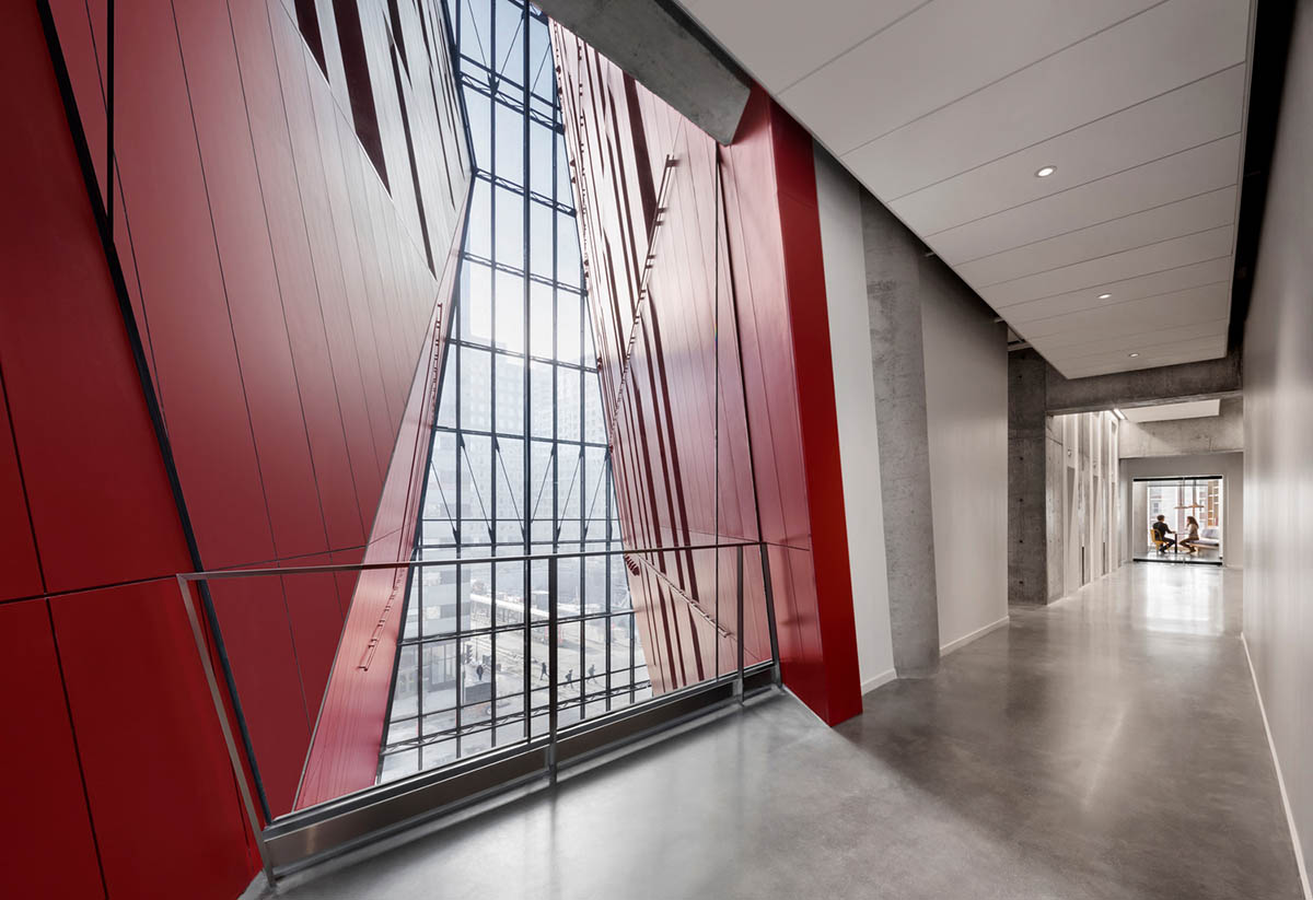 Provencher_Roy carves mixed-use office tower in Montréal with a red-colored diagonal slit