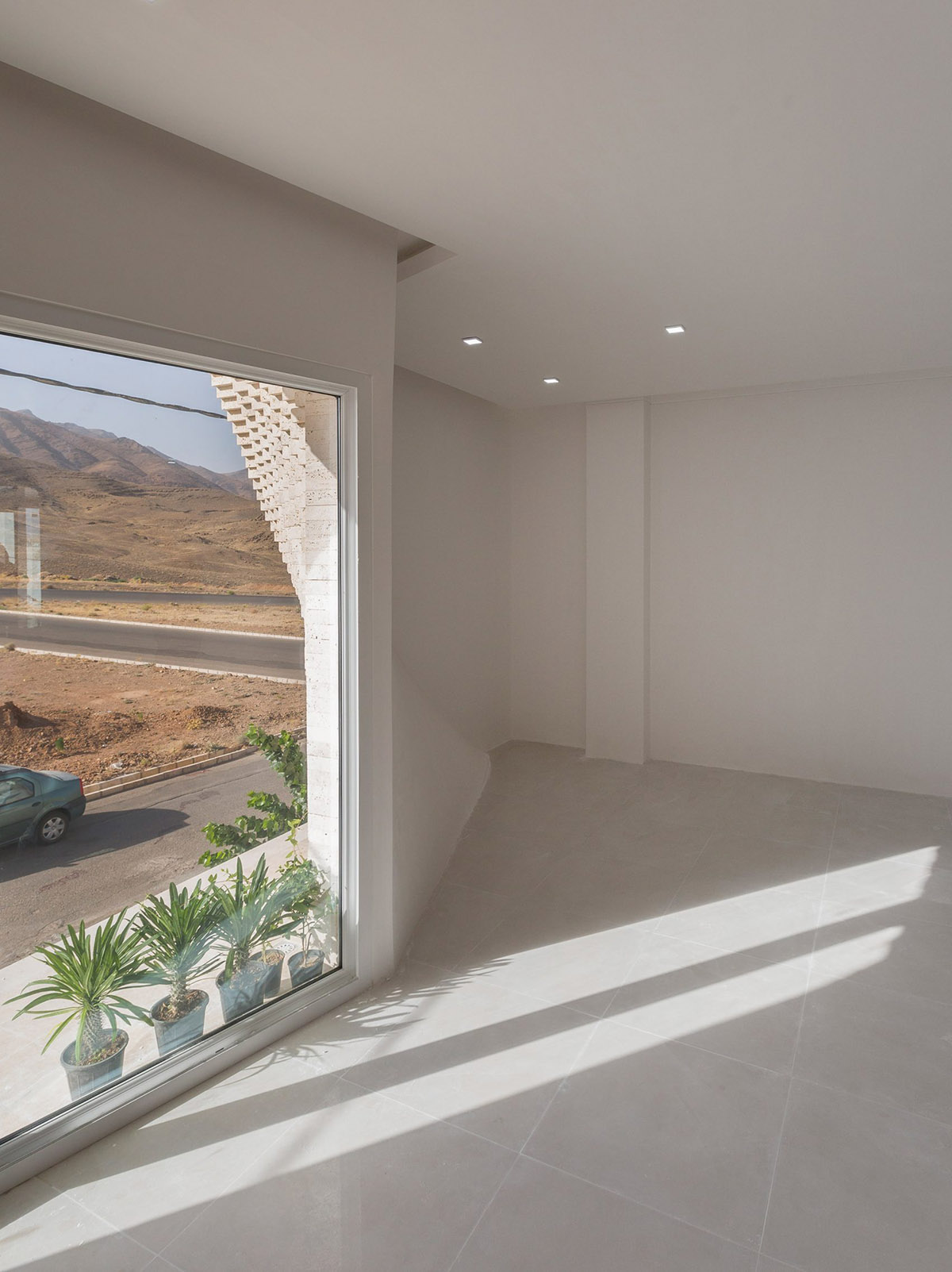 CAAT Studio creates spatial variations of stone on the facade of this Iranian residential building