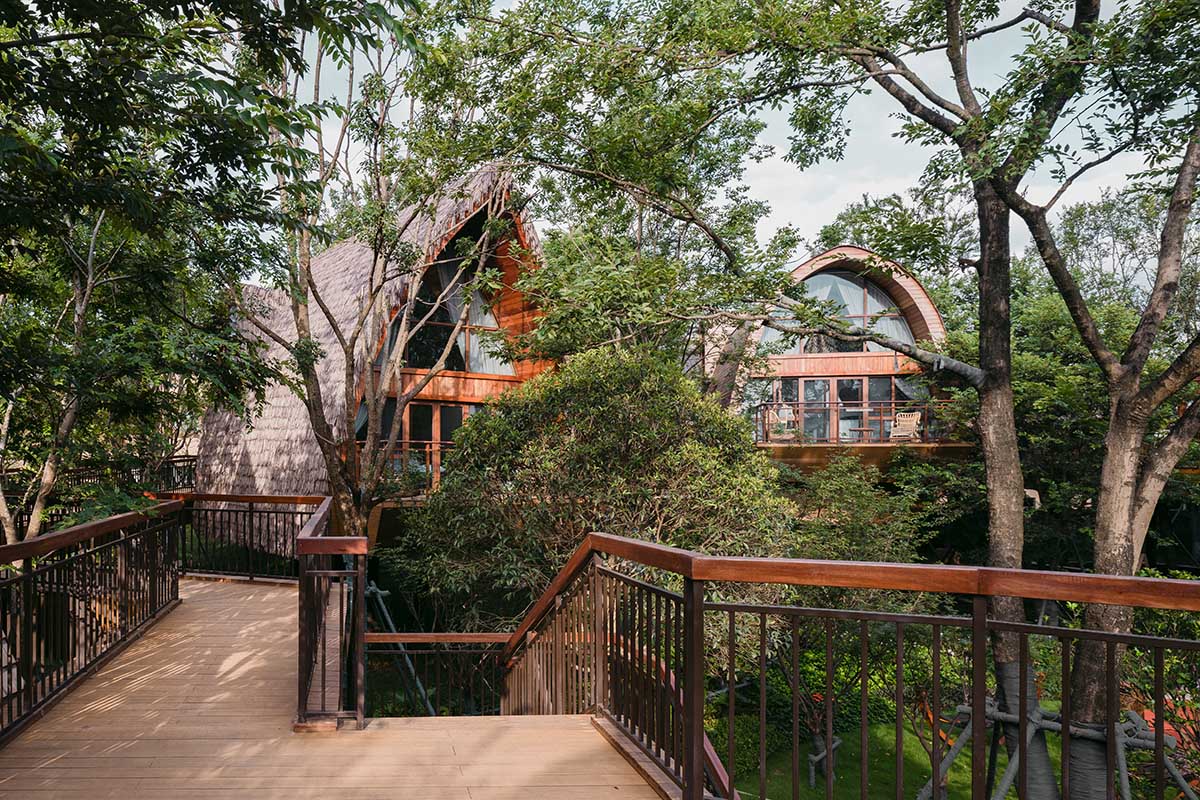 13 hotel cabins by aoe are plugged in trestle bridge that allows minimum footprint among lush trees