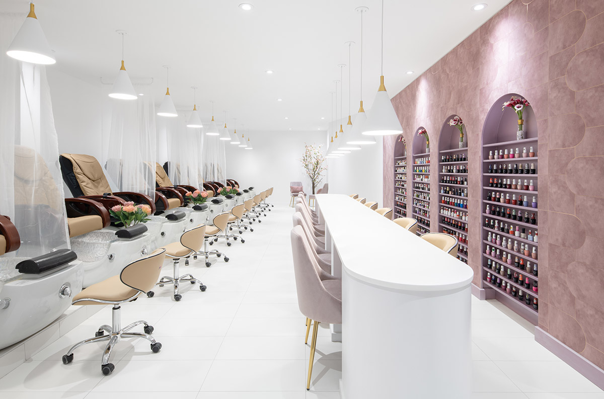 ISSADESIGN combines white backdrop with pinkish storage units for flower-inspired nail salon