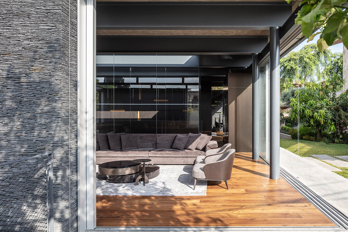 Pitsou Kedem Architects' black Pavilion House is reflected onto a linear swimming pool in Israel